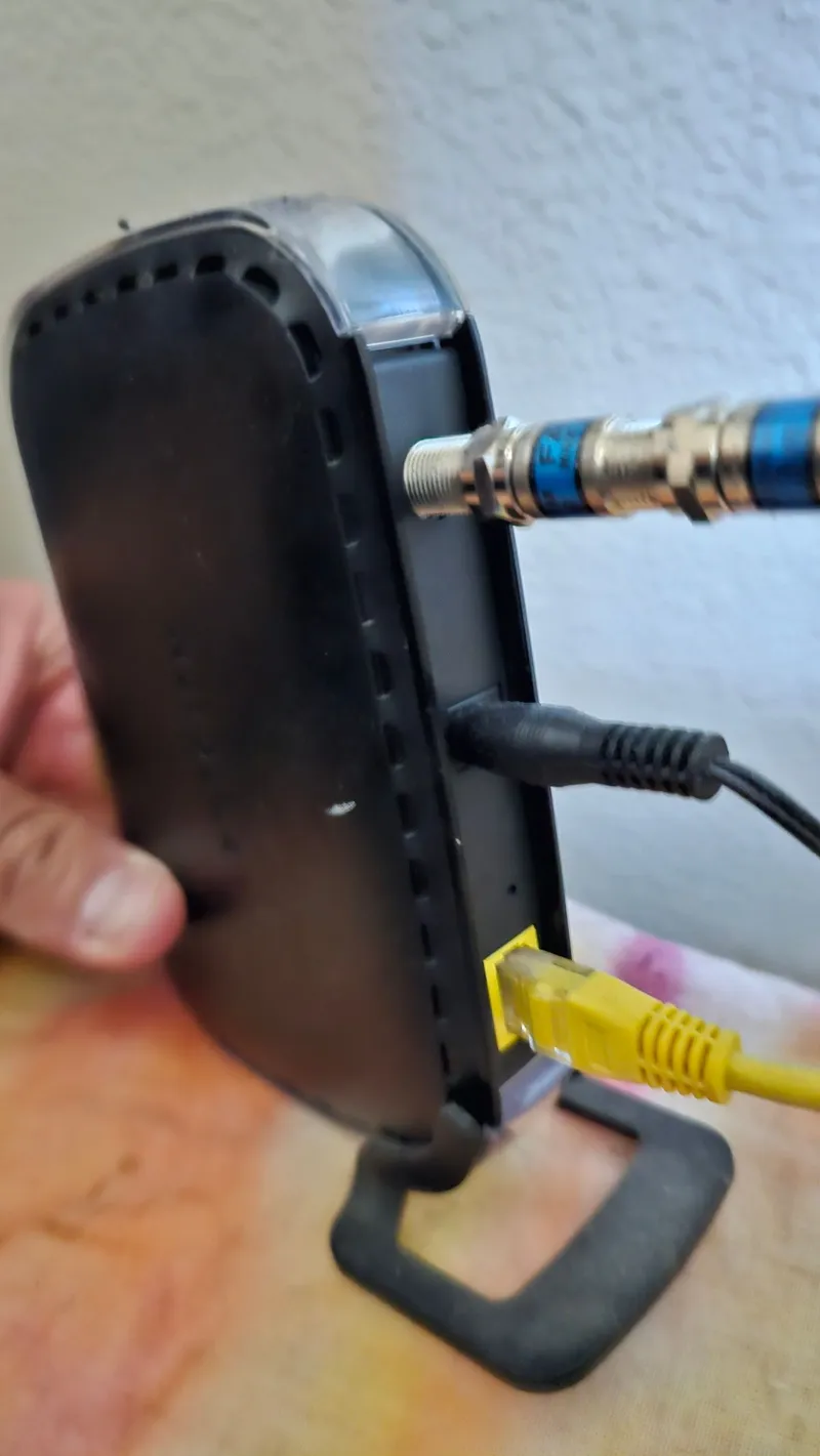 Connecting coax and ethernet cables to a cable modem during a home internet installation