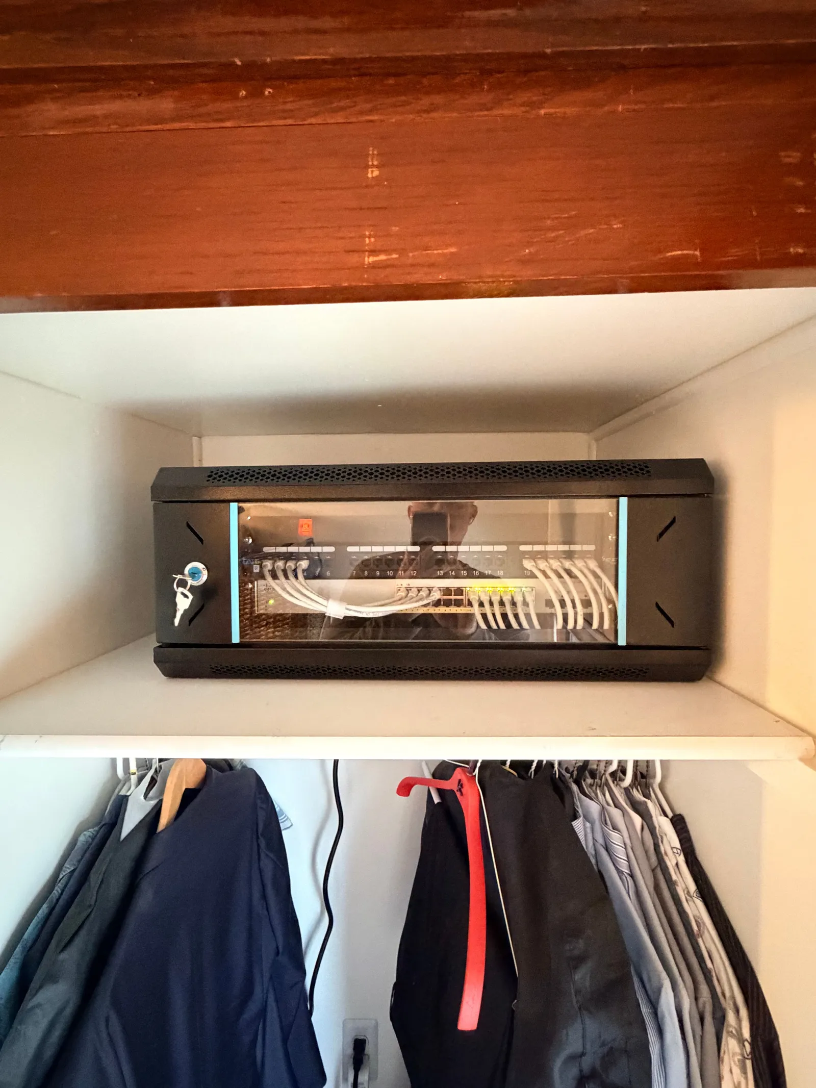 Neatly organized network cabinet installed in a home closet, an example of our finished work
