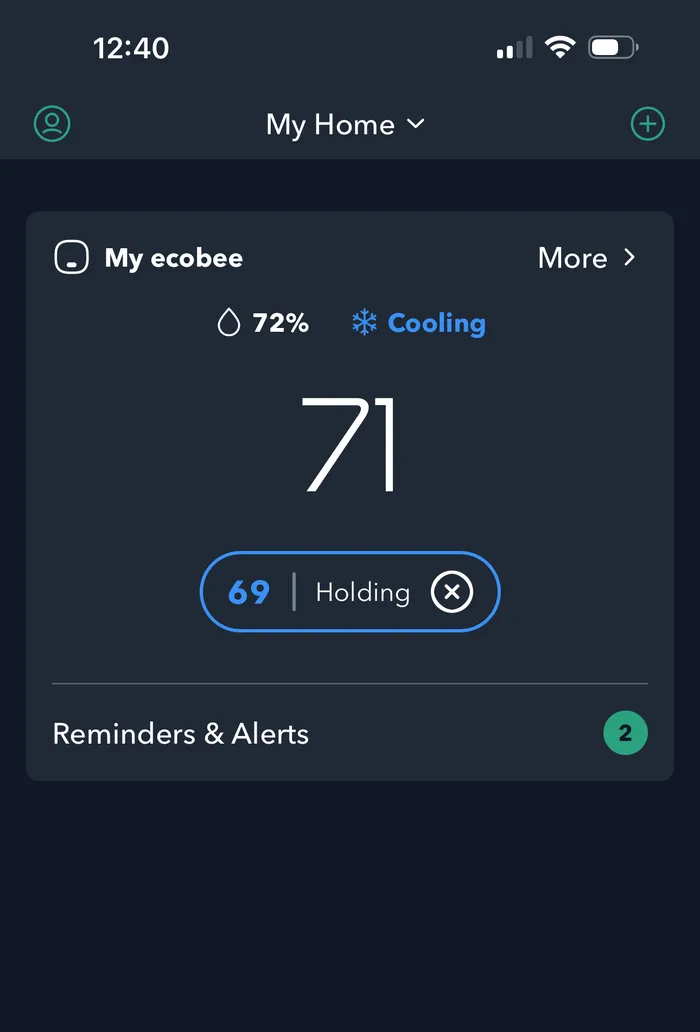 Thermostat app on a phone showing current temperature and cooling status for easy remote control